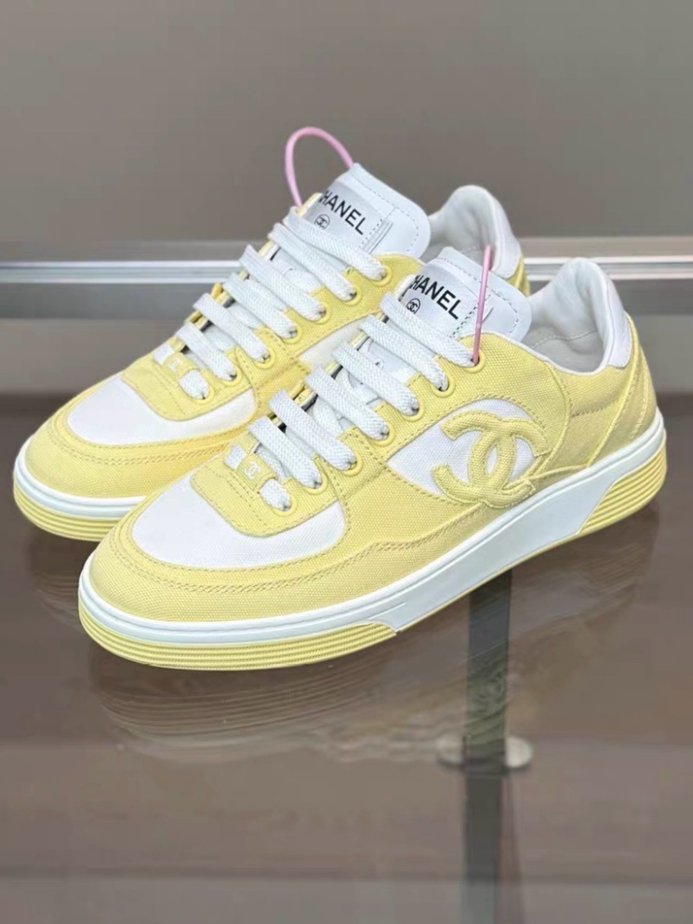 CHANEL Pastel Yellow & White Low-Top Sneakers with Pink Pull Tabs